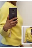 I've been looking for a nice lemon yellow sweater and I found this one. The knit is wonderful - great material, seems nicely made. The problem is when I tried it on it seemed to fit so strangely. The arms are really long and the neck seemed so huge! I ordered an XS and I normally wear fitted clothing, not slouchy, loose clothing. Because I've been wanting a sweater this color and that is hard to find, I thought I'd try to get it tailored... apparently sweaters can be tailored. But then a couple days later I decided to try it back on. I think it's OK. I pulled the sweater down so the neck wasn't so high and then it didn't look so bad and the sleeves apparently are supposed to be long so that you can bunch them up. I played with them a bit and now I think it doesn't need to be tailored, I just have to really style it well. Also, with it fitting so loosely, it doesn't provide much warmth. - Jennifer W.