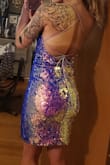 This dress is definitely an attention grabber. The color is absolutely radiant. It changes colors in different light settings. The material was stretchy, form fitting, without riding up. I was worry free all night. I received a copious amount of compliments on New Year's. The only downside is that some sequins did fall off. Once I took the dress off and inspected it, I could not locate where the sequins had came from, so who cares. If you want to make a statement, purchase this dress. You'll stand out like a sore thumb, in the best possible way. - Terra M.