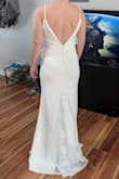 I ordered the small because I fit another Lulu's dress in small but because the material was stretchy this dress was so loose. The lace is very delicate in the train and it has a floral motif. The front is completely plain. It wasn't for me but I loved the back with the buttons. - Danielle D.
