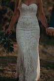 I wore this dress for my elopement in Ireland. It was perfect. The sequins add a heavy richness that I loved. The quality is good and the shape is super flattering. The pattern is gorgeous and hits you in the right spots. The under layer is not as much of a contrast as it looks in the pictures. I'm exchanged it for an XS because it's big around my bust. But the boning and shaping in the bust is perfect, no bra needed with the right fit. Absolutely loved it!! - Chelsea R.