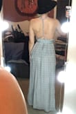 Loved everything about this dress and received lots of compliments. Tight enough in the waist band to feel secure up top but nice and flowy on the bottom. The slit is just the right amount of sexy. The material is light and slightly see through, so I recommend wearing a nude color spanxs/bottoms. I crisscrossed the dress in the front and twisted the straps down the middle of my back. I am smaller chested and it felt more comfortable this way. The straps are long enough that you can tie the dress multiple ways. This is a must have! - Ashley R.