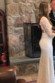 This Beautiful dress fits perfectly, shows the curves and the length was perfect with the hills. It touches the ground just a bit with hills but gives the touch to it. I used this for my civil wedding, everyone loved it and my husband couldn't resist. I totally recommend it. - Carla A.