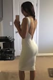 Material has stretch and is very flattering. I wish the liner was thicker as it is a bit see through. I thought the back was going to be even lower. It flattens my booty from the side view but more reason to do more squats! Comfortable, classy and sexy. - Nikki C.