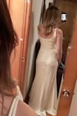 I bought this to wear as a reception dress for my wedding. It's heavy material which I love. I was worried it'd be thin or flimsy, but it's heavy and great quality. Straps are adjustable. It's a little long. I wore it with 2 inch heels, and I was just barely stepping on it. I can definitely walk around okay, but I might get an inch taken off the bottom just to be safe. Overall, I'm in love. It looks beautiful in person- pictures do not do it justice. Only issue would be the length but if you're a little taller, it'd be perfect. - Isha H.