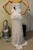 I tried this on as a potential wedding dress and each time I wore it, I loved it even more. Since I have an athletic/straight body type (my hips are actually 32 inches but Lulu's hip choices only go as small as 34), I didn't think a dress as form-fitting as this one would be flattering on me. However, it really accentuates the silhouette of my body nicely. I wasn't too sure about this dress the first time I wore it, but after trying on a few other dresses, this one is definitely the strongest contender! The XS size feels very secure so I'm not concerned about it slipping down (it is perhaps a little tight--the last few inches of the back zipper were difficult to close up but not impossible). The bodice has a nice, firm structure but isn't entirely stiff like an actual corset so it isn't as restrictive as it may seem.
I will need to get it hemmed and the zipper end over my butt is a bit lumpy (time to exercise those glutes!), but I'm very happy with this dress! I will likely accessorize with a nice belt to conceal the line on my midriff. - Akemi I.