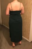 I returned it because I found a dress from a different store that was more flattering. I am heaviest in my stomach, thin in the waist and thick again in the thighs and butt. It was flattering, but the bust was a bit tight and in the front it sort of caused them to bulge out a bit at the top (can't tell in the pic). I ordered the green- it was a gorgeous, flattering color and it did cover some my back fat a little bit, too (though I have apparent rolls in the pic LOL). The slit could go up high if you moved a certain way. - Jennifer L.