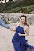I listened to another review and sized down, the dress was perfectly snug at my waist which is just how I like it. It was so comfortable, simple, classic, elegant. The Navy blue was perfect for our beach photos, can't wait to find another excuse to wear the dress again. It is quite long but I was able to get by without having it hemmed since I was just taking photos in it. I may consider hemming it an inch or two when wearing to an event. - Deidra S.