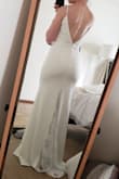 This dress is breathtaking. The medium was too big in my chest but fit perfect on my hips. The small is just a touch tight on my hips but fits my chest perfectly. It's perfect. The stretch of the dress itself is very flattering and comfortable. I will be wearing this for my wedding reception after I change out of my ceremony dress. The lace in the back of the dress is subtle and beautiful. So excited about this dress! I am sure it will blow my fiance away. - Rachel R.