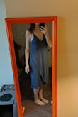 It's a comfy material dress. It's very low-cut in the front. The website says you can wear a adhesive bra with this dress, but that's absolutely wrong. There's no way. It's so low-cut, you would not be able to wear any kind of bra with this. I even adjusted the straps a ton just to get it to come up, but it's still very low-cut. I bought it for an upcoming vacation. - MARY B.