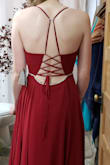 I purchased this dress for prom, and I ABSOLUTELY LOVE IT! I ordered a size larger than what I typically wear, but the straps in the back make it extremely adjustable. The straps are a little difficult to thread through the holes (have a pin ready), but do not budge after being laced up. I am going to need to alter the waist band smaller (but that is just because I have a small waist). With three inch heels, the dress is a little too long (I am wearing heels in the picture). The material is just as described and NOT "cheap-looking." The color is perfect, meaning not red but maroon/wine red. The slit is not too high and the neck is not too low. 100% recommend! - Izabella A.