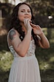 I ordered a size small and it fit perfectly according to my measurements and the size chart. This dress has a slightly pink undertone but nothing too crazy and fit the rustic theme for my wedding perfectly. I wore a trumpet silhouette slip underneath and it gave the dress a perfect amount of flare at the bottom. It's definitely a little see through without a slip so get one if you can. The lace detail over the top was beautiful. The dress got so many compliments and I am so pleased with it! I am absolutely in love with it. - Sara W.
