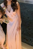 This dress is very true to the model photos. It was the slightest bit loose on top but was not a huge deal. The material was nice, I used an adhesive bra, would not have been able to do no bra. It was beautiful in a very simple elegant way. My heels were only a couple inches tall and I had to lift the dress to walk, so you need high heels or hemming if you're shorter/ average height. Overall I'm very happy I got this dress for my sister's wedding. - Stuti S.