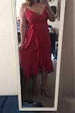 First of all, I ordered this dress is the berry color and the color is so rich and flattering. I would say the dress is worth it for the color alone. Very nice quality for the modest price, as well. I purchased this in an XL based off my previous Lulus purchases. The fit is quite nice, but it's a little loose under the armpits. I will have to have this part taken in, but that's not a big deal. I would rather have a little extra fabric than too little.This is a TRUE wrap dress, and thanks heavens it is! It is extreme flattering, a modest length which balances out the cleavage, and it's great with an hourglass figure. Highly recommend! For reference, I wear a number size 14 at other stores, and the XL fit perfect. - Ana P.