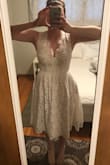 This dress fits great - I normally wear an XS & that's what I ordered. The cut in the front is lower than expected, but the lace detailed edge of the straps conceals most of the clevage. I will agree with others that say the layer of tule under the lace is too poofy so I'll be removing that. The pockets are sweet, lace is thick & nice quality. Plan to wear this for a laid back wedding reception. - Bobbi B.