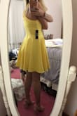 Vibrant beautiful yellow. Fits perfectly. Falls before the knee after my fingertips. Got it for my college graduation - Miranda B.