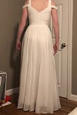 This dress is very pretty. The top is very flattering. I'm a smaller chested gal and I like that you can wear this without a bra and still get a little bit of cleavage! However, I don't really love how sheer the bottom is, especially with how flimsy the lining is & the high slit. Also, not quite long enough for me at 5'9. - Elissa S.