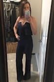 The material is very nice and has good stretch to it without being restrictive. I had to have the legs taken up 3 inches but that is no big deal. This is such an awesome jump suit. Perfect for date night or any special evening or event. I was even able to wear a regular strapless bra with it, which was such a nice surprise. I ordered it in black first and then in blue. Now I feel like I need it in all of the colors. - Cara R.