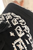 The material is great but it did look a little more grandma when I tried it on. I think the gold sequence through me of a bit. And the fit was weird. Loose and flowier up top but than at the bottom it gets tighter. Really wanted to love this one but just wasn't for me. Ended up returning. - Renee B.
