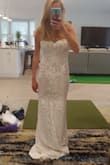 I am so in love with this dress. I am wearing it to my beach wedding. It fit greats though it is a little long. Expect to get it hemmed if you are on the shorter size. Pictures do not do the dress justice for how beautiful it is! - Erin O.