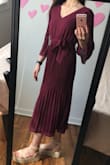 I am excited to wear this dress! I ordered it to wear to church and to some weddings I have this summer, and it's perfect. The color is stunning, the v isn't too low, the pleats are fun, and the bow is cute and slimming for the waist. The back is sheer, so my bra may be seen a little, but I don't mind that. It is a little long too, but with heels it'll look great. - Liz R.