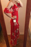 Such a fun dress! I'm usually between a 4/6 or S/M in dresses, I sized up for this dress based on other reviews regarding the waist and, although the fit was a little loose, I don't think another size would have fit as well. I do plan on wearing Spanx with it because the material clung to my belly more than I would like. Love the red color, the sheer off-the-shoulder sleeves, and the unique bottom cut! - Sarah Q.