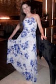 The dress looked even prettier in person! The skirt is flowy and the straps in the back are long enough to adjust to your desire. Good material. I had the dress shorten a bit so I could wear it with flats. - Alicia N.