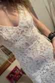 This dress is amazing! The reviews are totally accurate, it's a great buy. I ordered it in both the small and xs to compare sizes. I wasn't sure because based on girls around my size some chose a small and some xs. For me, the xs fit a little better, but I'm still unsure which one I'm going to keep. My only COMPLAINT is the underlay... it's beige. It's hard to tell in some photos but very noticeable in mine. I'm not sure if this was made previously with a white underlay?? Lulus feel free to let me know! Lol. It's still cute and I'm on a budget so I definitely can get over it, but I think it would look nicer with a white fabric under the lace instead of the beige. It's also a little see through but obviously on the big day we aren't going to be wearing bright undies. ;)
Regardless, the dress is stunning and I'm definitely going to wear it as my wedding dress when the day comes! I wish I had a cool photo in it but so far all I have is ones from my room trying it on. - Kassidy H.