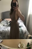 This dress had me concerned because reviews can be quite mixed and how it fits on ladies with smaller waists than me was mixed. The band DOES NOT stretch so consider that when you order. It's a top clasp and zip up on the back of the dress. Overall, I am so excited to wear this as a bridesmaid for my friends wedding. I am very happy it fit me, but I read the reviews a lot before ordering my size. This dress makes you feel like a goddess. :) - Jenna R.