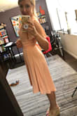I am a petite human with a larger bottom (s/m) than top (xs/s), so finding the right style/fit is always a challenge. The wrap on this dress allows for you to pull it tighter and make adjustments to the top portion while not being tight at all on the bottom area. Very comfortable and flowy -the color is great for spring and looks just like it does in the photo. Recommend fa sho!
I tied it a little differently than the photo, and I'll probably continue to mess with it until I get a bow I like, but it's great for the beach wedding I'm going to in April. - Lisa P.