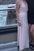 The pink color was stunning and the dress was super comfy. Love the slit and adjustable straps. It is pretty long. I hemmed the outer layer 3 or 4 inches and am wearing 3 inch heels. - Megan P.