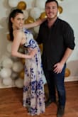 The dress is beautiful. I love the crisscross back! I am 5'4.5, and with a 3 inch heel I was able to wear the dress without a hem, but it did catch under my feet often and I spent most of the night of a party using my hands to hoister it up so I wouldn't step on it. If you plan to do a lot of dancing in this dress or wear it with a practical use (ie. Not just take engagment pictures in it), then you'll want to hem it. Also, it clearly won't wear with a bra with any sort of backstrap, so stickies or other front cup bras are a must. I wore a bralette underneath for a less formal party because I didn't have the correct undergarments and it worked fine for that event. If I was going to a wedding or some sort of formal, I would have needed to get the appropriate pieces. Other than that I must tell you ladies that this dress made me want to dance all night long! It's very comfortable, excellent quality, and the skirt is super flowy and fun to dance in. 
P.S. please excuse the awk photo. just trying to show yall the side of the dress  ;) - Abby H.