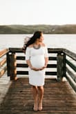I actually wore this dress for my maternity pictures and baby shower. The fabric is a little thicker than expected but perfect since the dress was white and it was a little chilly for a Spring shoot. The dress is stretchy and worked out great! I was concerned about the length since I'm short but with the help of my bump it ended up being the perfect length - right above the knee keeping it super classy. With an off the shoulder dress I always worry about the sleeves hiking up but that wasn't the case. It stayed in place for both the photo shoot and shower. I love this dress! - Stephanie K.