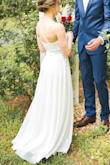 This dress was perfect for my wedding! Exactly the combination of simple yet elegant I was looking for. When I had it shortened, I had them leave a really small train in the back so it looked a bit more "bridal". I also had it taken-in at the waist because I wanted it to be tighter and to fit perfectly (if I had not done this it would have still been wearable). The quality is great considering its price - the dress skirt definitely has some weight to it. I'd also like to note that the color is slightly off-white, but you would only be able to notice when comparing it against something truly white. I feel like this is the type of dress that would be flattering on any body shape. Overall, this dress was worth it and I would definitely recommend! - Paige S.