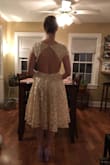 I bought this with the intention of wearing it to my bridal shower. It's very cute! It has sort of a vintage vibe with just enough edginess with the open back and low cut front. I bought a small, and it fits very well. I think I possibly could have fit into an extra small since my chest is on the smaller side, but I'm fine with how it fits, so not going to exchange. The material is good quality. I got the ivory color, and it is definitely a warmer, darker ivory color, not white at all, so just keep that in mind. It is fun to twirl around in because the skirt flares out! It's very low cut, but I feel comfortable in it and did not need to wear a bra. I might use some tape when I wear it, just to feel extra secure since I won't be wearing a bra. I almost want to order this in the lavender color too! - Carly S.