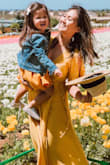 I got this in yellow and it was the perfect dress to wear the flower fields to match with my daughter. It was bright, airy and the perfect length. I wore flat shoes and am not the tallest, but it landed right at my feet. Usually maxis are super long even with heels, but this was perfect! I wore it with chucks and a denim jacket, but it can also be dressed up if I want. Just make sure to iron it out because it does get crinkled easily. But other than that, I love this dress. - Genny N.