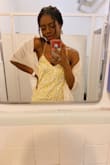 I loved the dress! I brought the red in a medium and this in a small. This one fit better, and I love how the strap is adjustable. It's flowy but doesn't have stretch which allows for the dress hug your curves. - Chia M.