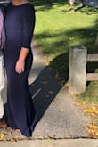 This dress is form - fitting, classy, and the back is absolutely stunning. Has ribbing in the back to keep the back/shoulders in place. So happy with this purchase. I'd but it in more colors if I had another wedding to wear it to! - Alyssa D.