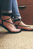 These sandals are really comfy. The straps on the black sandals are a faux suede that's soft, so I don't foresee any blisters as I've had with other new sandals with straps between the toes. I had originally ordered size 7.5 which is what I always wear but had about extra half inch sticking out from the back. I returned them and ordered size 7. In my case, these run large or too long. The return process was painless. I work in an office setting but very casual construction business so i can dress these up or down. I also like that the straps feel snug and secure on my feet unlike other strappy sandals that feel like they're going to fly off your feet as you walk. This was my first purchase from Lulus and so far I am totally impressed. - Ileana C.