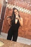 Love this jumpsuit. Material is great quality. I was a little nervous about the front being too low, but it wasn't at all. I'm not very busty so I think that helps. Got a million compliments. Love Lulus. I even called before to verify size because the pics of other women were throwing me off. It seriously depends on your build. I'm 140lbs but it's more in my booty and legs which is the reason I got away with a small. It fit perfect! - Brittney M.