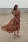 This dress is beautiful; the material is so soft and comfortable. I wore this dress to a beach wedding and I can't say enough about it. My one complaint was the size of the top, for a small it was a little large, but all in all I think it wore well.
On a windy beach it was a little difficult to keep the front from flying open because it is a true wrap dress, but if I had to go back and pick a dress again for this wedding I would pick the same one.
Last thing for you tall ladies out there, this is a small and it was almost too long in the back! So worry more about the actual dress size than the length. - Elizabeth B.