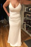 Very flattering! I ordered the white in a medium and the black in the large. The large and black were much more flattering while the white showed my flaws. - Cheryl B.