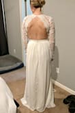 This dress is very pretty. I ended up returning it, because it wasn't what I was looking for once I tried it on. The sleeves are not fitted to your arms, but overall it still is a very pretty dress! - Mallory C.