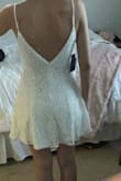 A lot of material on the skirt part of the dress, so it looks more like pleats than an empire waistline. I love the material and the buttons and the low back. It's stunning quality and looks just like the photo. I'd say go down a size though if you want a better fit! - Luana B.
