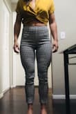 These pants looked so chic in the photos on the model, so I bought them to add to my rotation of professional attire; big mistake. They were tolerable when I first put them on but felt SO unbelievably uncomfortable when I tried to sit. No way I could even sit in my car to drive to work (notice how the model isn't sitting in them- she's just leaning on the stool...). I have a very muscular build with larger quads and these pants are horrible on my figure. The medium fit my waist- standing still, but the legs were so tight on me. If I sized up to a large they would've fit my legs better, but they don't have loops for a belt so they'd gape even worse around my waist. They hit at my belly button which was exactly what I wanted with some of my shorter blouses, and they seemed like they fit when I stood still, but they gape in the back when I sit revealing my underwear, and the front part cuts into my stomach. In the picture of me sitting I pointed to where the waist hits when I'm standing so you can see how far they come down when you sit. Peep the top of my underwear that were tucked down as far as they could go... And they fell down on my legs as soon as I took a few steps in them. The material is stiff and feels cheap, I'd definitely return them if I could. Honestly, save yourself the trouble if you plan on doing anything other than standing like a statue once you put them on. - Maddy K.