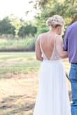 I fell in love with this dress before I was even engaged but I knew when the day would come, I would definitely buy this dress. Buying online can be scary but this dress is by far prettier than most dresses in a bridal boutique. It fit me perfect, I did have the bottom hemmed so I wasn't stepping on the front of it and I had a bustle added as well. The only thing I did not like was where the dress has the placement for handing it. It's on the material under your armpit so when you try to cut it off or I had it moved so you can still see an area of it. I would recommend placing it lower in the dress where it is not visible. - Brittney F.