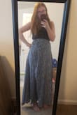 After reading the reviews I went with a Large and I should have sized up. I'm at the very edge of it being too tight but I'm trying to lose weight so I'm keeping it. It's a false wrap (side zipper) with two sewn in ties you can tie in the front. It's a super cute skirt that is lightweight but you can't see through! When the wind picks up, just keep ahold of your skirt or you will end up with as much leg showing as the model (or in my case I flashed my husband, oops). - McKenna I.