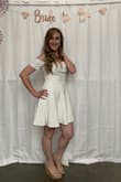 I wore this dress for my bachelorette party this past weekend and it fit so comfortably! I received so many compliments on it and I thought it felt very flattering. The material is thick which is nice because I wore black shorts under (didn't have any other color to wear) and you couldn't tell. I could recommend wearing some kind of pasty or those sticky bra things because I felt like my bra kept showing. I didn't have to bother pulling it up too much during the night. I would recommend this dress to anyone!! - Heather C.