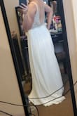 The dress was pretty. It's very long for someone my height. I also found it to be loose in the back. It looked nice but for the price I returned it to get something that fit better. - LAUREN K.