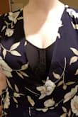 Compared to some other dresses from this site, this one runs a little smaller. It "fit" but didn't wrap around enough to cover the bust. 
It is cute though: hits right above/at the knees on the front and slightly touches ground the the back (probs need to be 5'8" to have it not touch the ground at all). It is flattering at the waist as well.

The flowers were this weird dusty blue-green color (not real or turquoise but parts blueish, parts greenish). It could be a little matronly for some tastes. If you order it in a size up, I'd probably consider a brighter color.

Photos show it in (overcast) natural light and fluorescent light. - Lauren A.