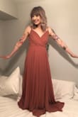 This dress is so pretty. It's fully lined and the straps are adjustable, so it doesn't reveal too much. It is LONG though. I spent more than the dress cost just getting it hemmed. Worth it. :) - Alison F.